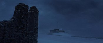 Movie still from “The Day After Tomorrow” (2004), directed by Roland Emmerich – A building on top of a hill in the middle of the night; Extreme Wide shot, Low angle