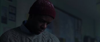 Movie still from “The Day After Tomorrow” (2004), directed by Roland Emmerich – A man wearing a red hat and a sweater; Close Up shot, Low angle