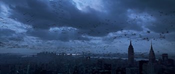 Movie still from “The Day After Tomorrow” (2004), directed by Roland Emmerich – A flock of birds flying in the sky over a city; Extreme Wide shot, High angle