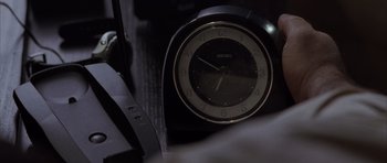 Movie still from “The Day After Tomorrow” (2004), directed by Roland Emmerich – An alarm clock sitting on top of a table; Extreme Close Up shot, Overhead angle