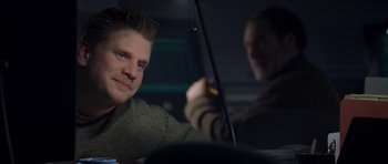 Movie still from “The Day After Tomorrow” (2004), directed by Roland Emmerich – A man sitting in the back of a car holding an umbrella; Close Up shot, Over the shoulder angle