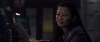 Movie still from “The Day After Tomorrow” (2004), directed by Roland Emmerich – A person sitting at a table; Close Up shot, Over the shoulder angle