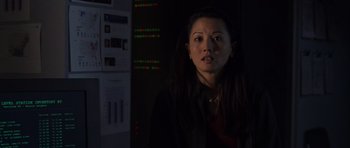Movie still from “The Day After Tomorrow” (2004), directed by Roland Emmerich – A woman standing in a dark room looking at the camera; Close Up shot, Over the shoulder angle