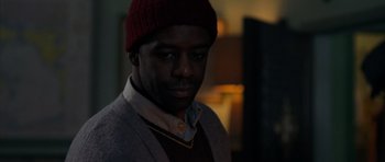 Movie still from “The Day After Tomorrow” (2004), directed by Roland Emmerich – A person wearing a jacket and a hat; Close Up shot, Over the shoulder angle