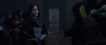 Movie still from “The Day After Tomorrow” (2004), directed by Roland Emmerich – A woman holding a cell phone in her hands; Medium shot, Over the shoulder angle