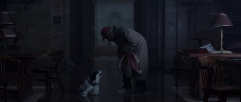 Movie still from “The Day After Tomorrow” (2004), directed by Roland Emmerich – A man and a dog in a dark room; Wide shot, High angle