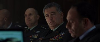 Movie still from “The Day After Tomorrow” (2004), directed by Roland Emmerich – A group of men in military uniforms sitting next to each other; Close Up shot, Over the shoulder angle