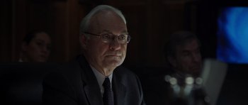 Movie still from “The Day After Tomorrow” (2004), directed by Roland Emmerich – An older man wearing glasses and a suit and tie; Close Up shot, Over the shoulder angle