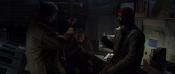 Movie still from “The Day After Tomorrow” (2004), directed by Roland Emmerich – A group of people that are sitting in the dark; Medium shot, Over the shoulder angle