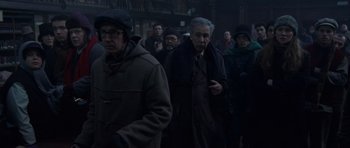 Movie still from “The Day After Tomorrow” (2004), directed by Roland Emmerich – A group of people standing in a dark room; Medium shot, Low angle
