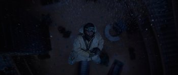Movie still from “The Day After Tomorrow” (2004), directed by Roland Emmerich – A man in a snow suit is hanging from a rope; Wide shot, Overhead angle