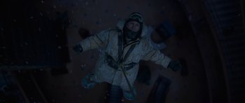Movie still from “The Day After Tomorrow” (2004), directed by Roland Emmerich – A man in a parka is flying through the night sky; Wide shot, Overhead angle
