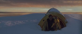 Movie still from “The Day After Tomorrow” (2004), directed by Roland Emmerich – A man in a yellow tent in the snow; Wide shot, High angle