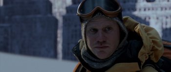 Movie still from “The Day After Tomorrow” (2004), directed by Roland Emmerich – A person wearing goggles and a jacket; Close Up shot, Over the shoulder angle