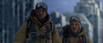 Movie still from “The Day After Tomorrow” (2004), directed by Roland Emmerich – A man and a woman wearing winter gear; Medium shot, Low angle