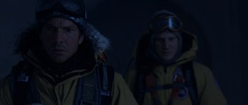 Movie still from “The Day After Tomorrow” (2004), directed by Roland Emmerich – Two men in yellow jackets are standing next to each other; Close Up shot, Low angle