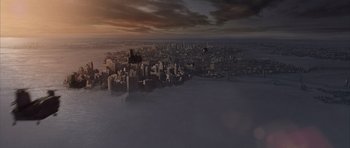 Movie still from “The Day After Tomorrow” (2004), directed by Roland Emmerich – An aerial view of a large city at sunset; Extreme Wide shot, High angle