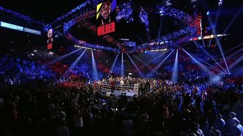 Movie still from “The Day the Music Died/American Pie” (2022), directed by Mark Moormann – A crowd of people watching a boxing match; Extreme Wide shot, Overhead angle