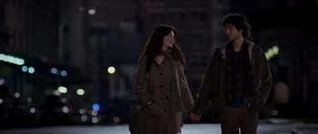 Movie still from “The Devil Wears Prada” (2006), directed by David Frankel – A woman holding hands with a man while walking in the dark; Medium shot, Over the shoulder angle