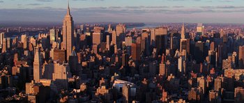 Movie still from “The Devil Wears Prada” (2006), directed by David Frankel – An aerial view of a large city at sunset; Extreme Wide shot, High angle