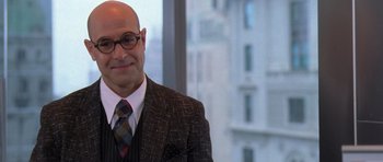 Movie still from “The Devil Wears Prada” (2006), directed by David Frankel – A man in a suit and tie in front of a window; Close Up shot, Over the shoulder angle