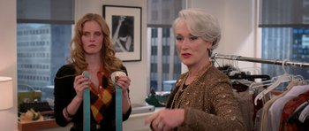 Movie still from “The Devil Wears Prada” (2006), directed by David Frankel – Two women standing next to each other in a room; Medium shot, Over the shoulder angle