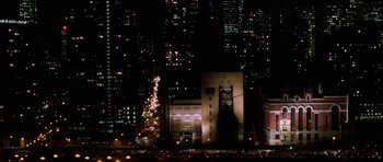 Movie still from “The Devil Wears Prada” (2006), directed by David Frankel – A building with a christmas tree on top of it in the dark; Extreme Wide shot, High angle
