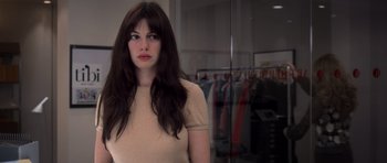 Movie still from “The Devil Wears Prada” (2006), directed by David Frankel – A woman standing in front of a mirror in a room; Close Up shot, Over the shoulder angle