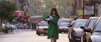 Movie still from “The Devil Wears Prada” (2006), directed by David Frankel – A woman in a green coat and leopard print gloves; Medium shot, Low angle