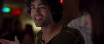 Movie still from “The Devil Wears Prada” (2006), directed by David Frankel – A person smiling; Close Up shot, Over the shoulder angle