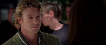 Movie still from “The Devil Wears Prada” (2006), directed by David Frankel – A person wearing a green jacket; Close Up shot, Over the shoulder angle