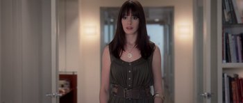 Movie still from “The Devil Wears Prada” (2006), directed by David Frankel – A woman with long black hair standing in a room; Medium shot, Over the shoulder angle