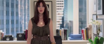 Movie still from “The Devil Wears Prada” (2006), directed by David Frankel – A woman standing in front of a window in a room; Medium shot, Over the shoulder angle