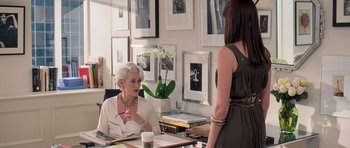 Movie still from “The Devil Wears Prada” (2006), directed by David Frankel – Two women sitting at a table in front of each other; Medium shot, Over the shoulder angle