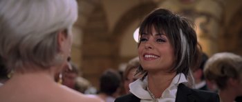 Movie still from “The Devil Wears Prada” (2006), directed by David Frankel – A woman smiling at the camera while wearing a white blouse; Close Up shot, Over the shoulder angle