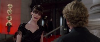 Movie still from “The Devil Wears Prada” (2006), directed by David Frankel – A woman in a black dress talking to a man in a black suit; Medium shot, Over the shoulder angle