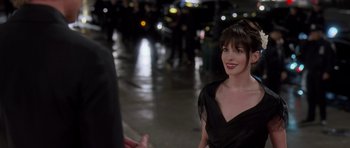 Movie still from “The Devil Wears Prada” (2006), directed by David Frankel – A woman in a black dress standing next to a man in a black suit; Close Up shot, Over the shoulder angle