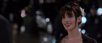 Movie still from “The Devil Wears Prada” (2006), directed by David Frankel – A person smiling for the camera; Close Up shot, Over the shoulder angle