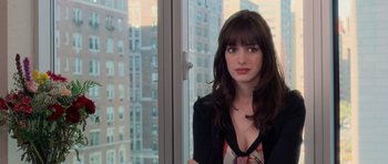 Movie still from “The Devil Wears Prada” (2006), directed by David Frankel – A woman standing in front of a window with a city view; Close Up shot, Over the shoulder angle