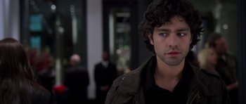 Movie still from “The Devil Wears Prada” (2006), directed by David Frankel – A man that is looking at the camera; Close Up shot, Over the shoulder angle