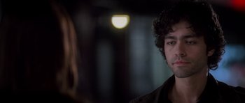Movie still from “The Devil Wears Prada” (2006), directed by David Frankel – A man with curly hair is looking at a woman; Close Up shot, Over the shoulder angle