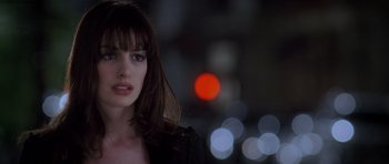 Movie still from “The Devil Wears Prada” (2006), directed by David Frankel – A person wearing a black jacket; Close Up shot, Over the shoulder angle