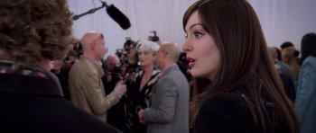 Movie still from “The Devil Wears Prada” (2006), directed by David Frankel – A person with a crowd of people; Close Up shot, Over the shoulder angle
