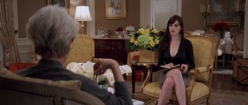 Movie still from “The Devil Wears Prada” (2006), directed by David Frankel – A woman sitting on a chair in front of a man; Medium shot, Over the shoulder angle