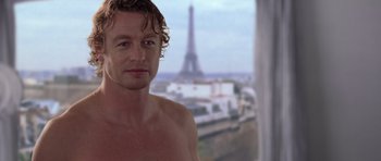 Movie still from “The Devil Wears Prada” (2006), directed by David Frankel – A shirtless man in front of the eiffel tower in paris; Close Up shot, Over the shoulder angle