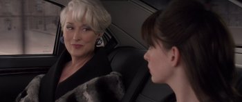 Movie still from “The Devil Wears Prada” (2006), directed by David Frankel – Two women sitting in the back seat of a car; Close Up shot, Over the shoulder angle
