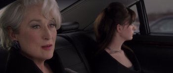 Movie still from “The Devil Wears Prada” (2006), directed by David Frankel – Two women sitting in the back seat of a car; Close Up shot, Over the shoulder angle