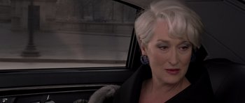 Movie still from “The Devil Wears Prada” (2006), directed by David Frankel – A person sitting in a car; Close Up shot, Over the shoulder angle