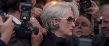 Movie still from “The Devil Wears Prada” (2006), directed by David Frankel – A person wearing a black jacket; Close Up shot, Over the shoulder angle