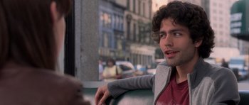 Movie still from “The Devil Wears Prada” (2006), directed by David Frankel – A man sitting on a bus in the city; Close Up shot, Over the shoulder angle